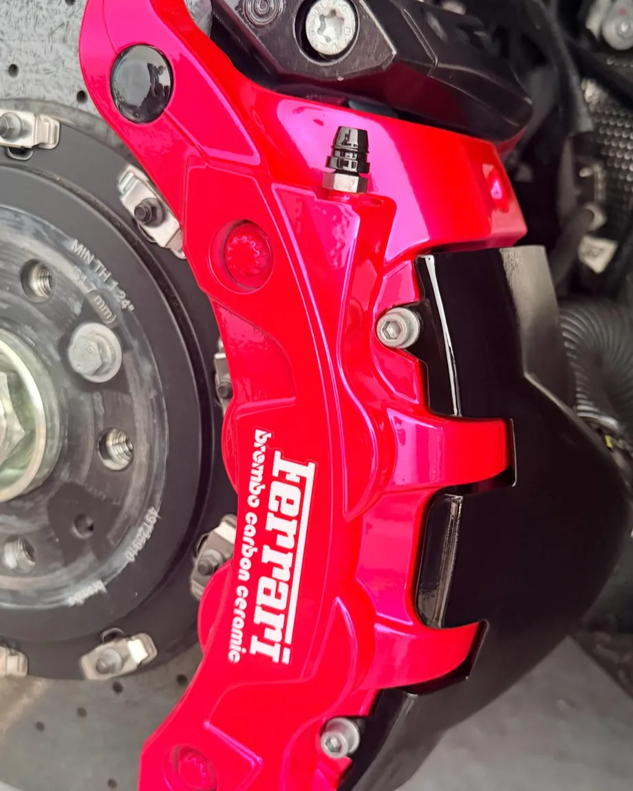 Ferrari caliper refinished in magenta