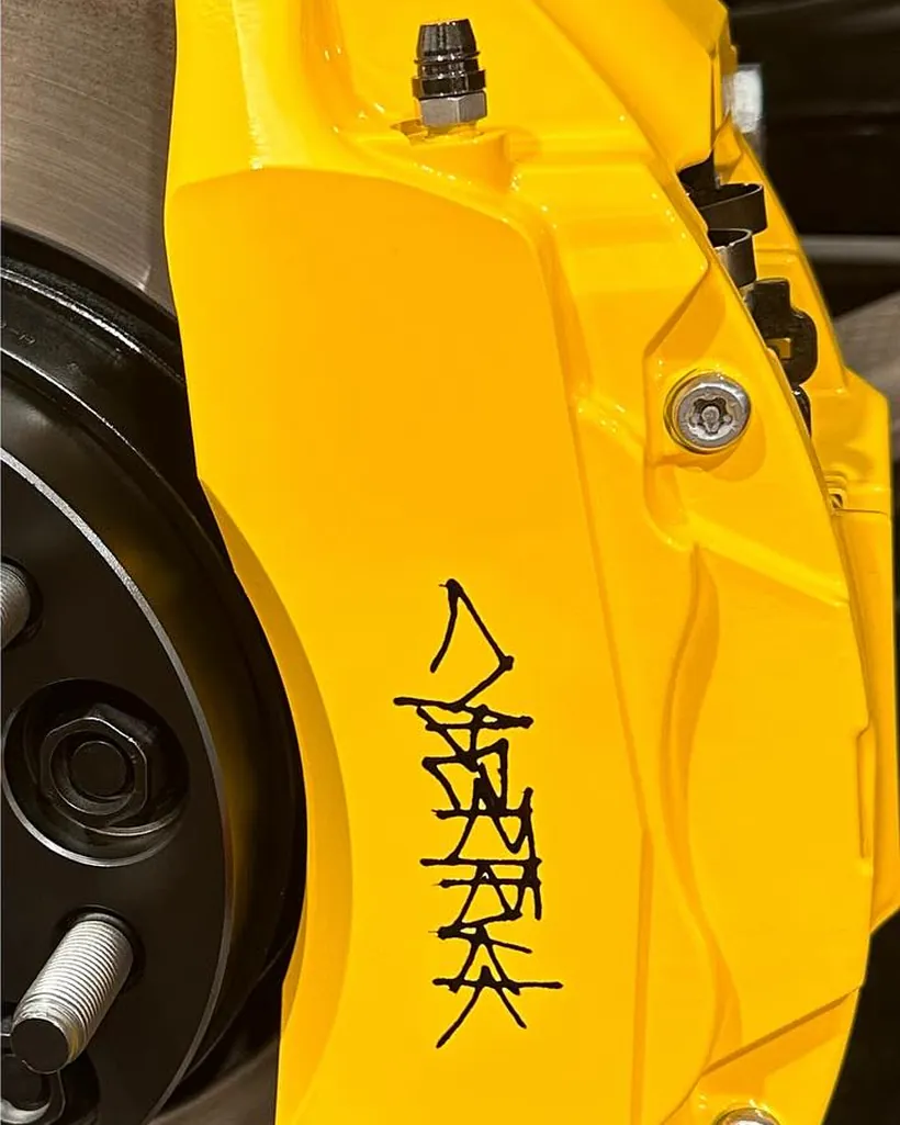 Yellow caliper with a hand-painted custom logo